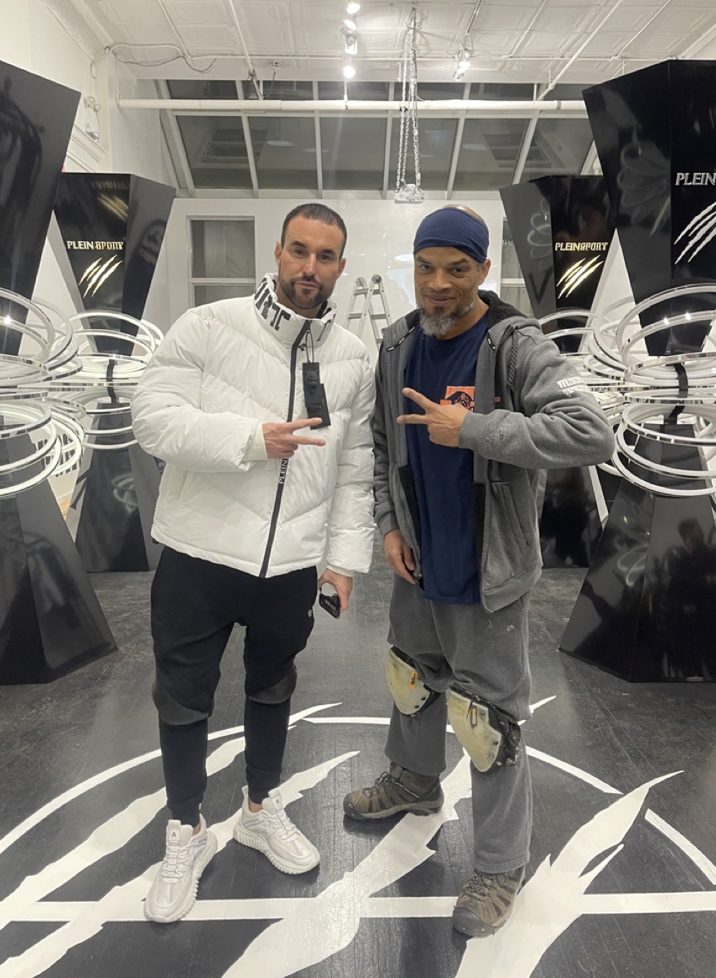 Kwazi posing with Philipp Plein in front of the finished claw-mark floor graphic