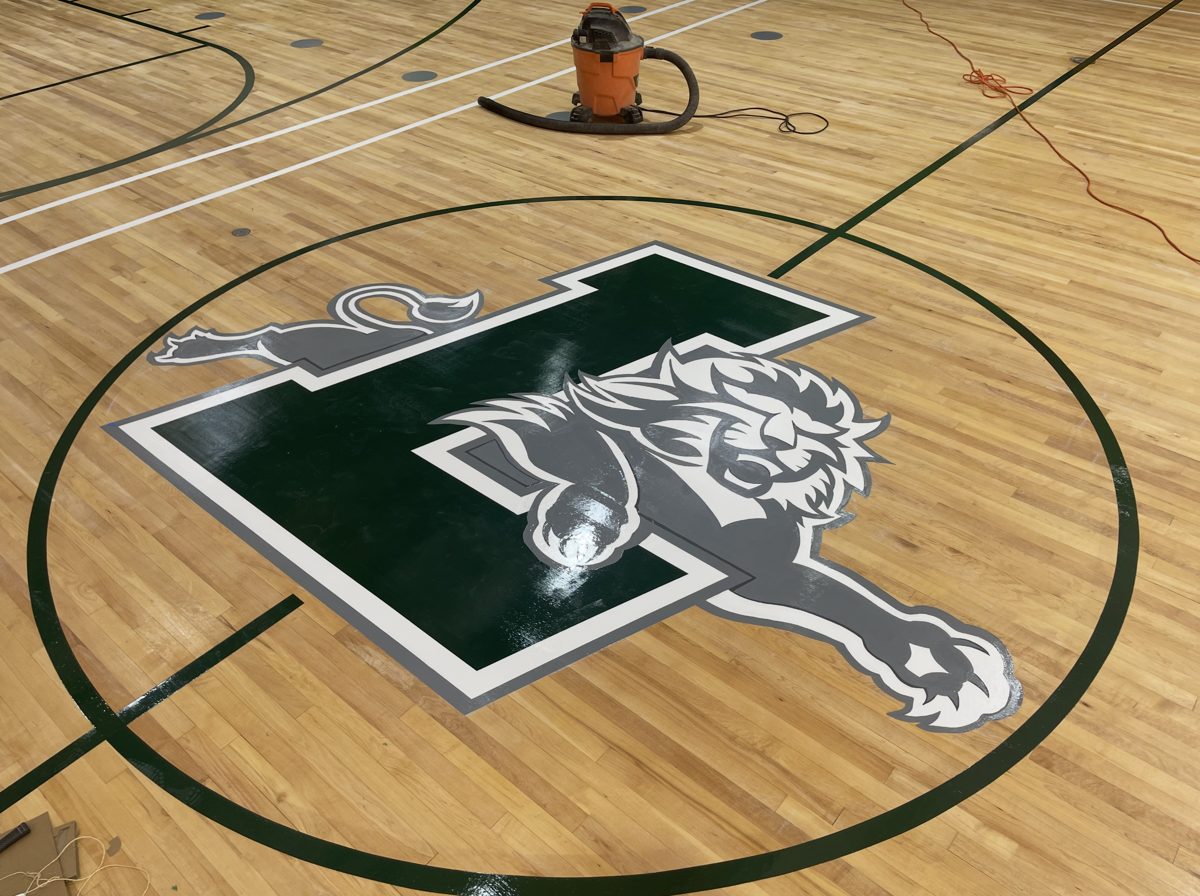 Lion and L logo painted at center court before final finish coats