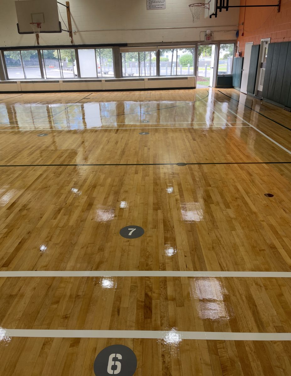 Finished glossy gym floor with numbered court markers