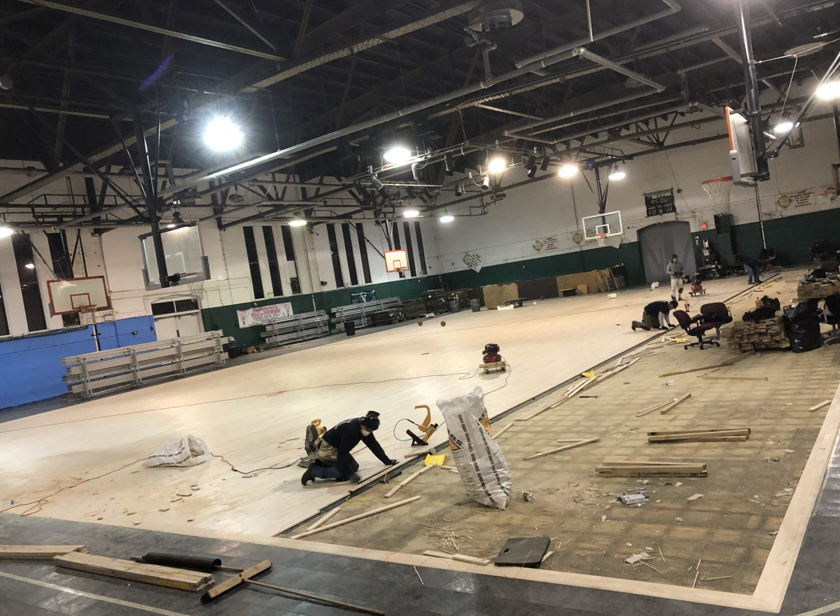 Angled view of the new hardwood spreading across the court