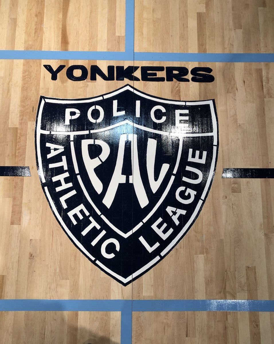Finished custom navy and white Police Athletic League logo painted on the new hardwood court