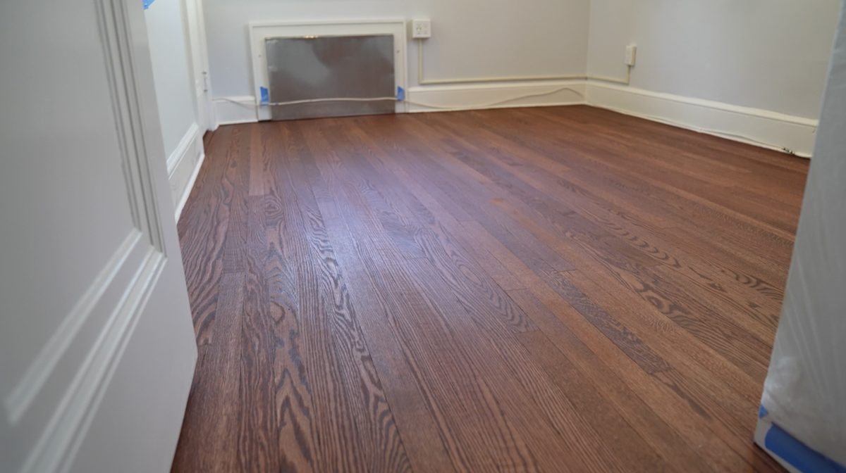 Finished stained oak floor in a bedroom with warm brown tone